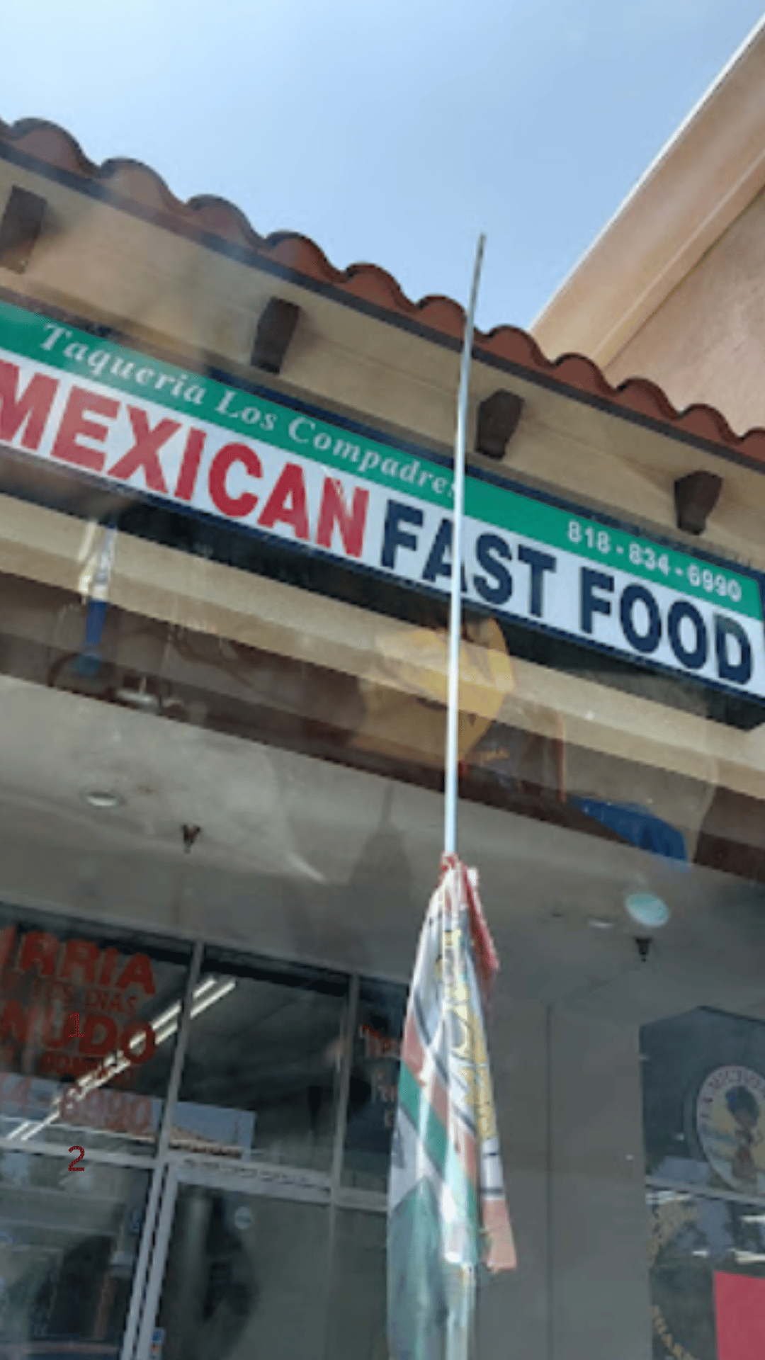 Exterior of Taqueria Los Compadres showcasing its traditional Mexican fast food sign and inviting storefront.